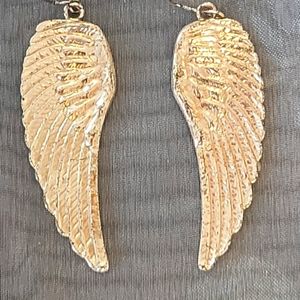 Gold angel wing earrings.